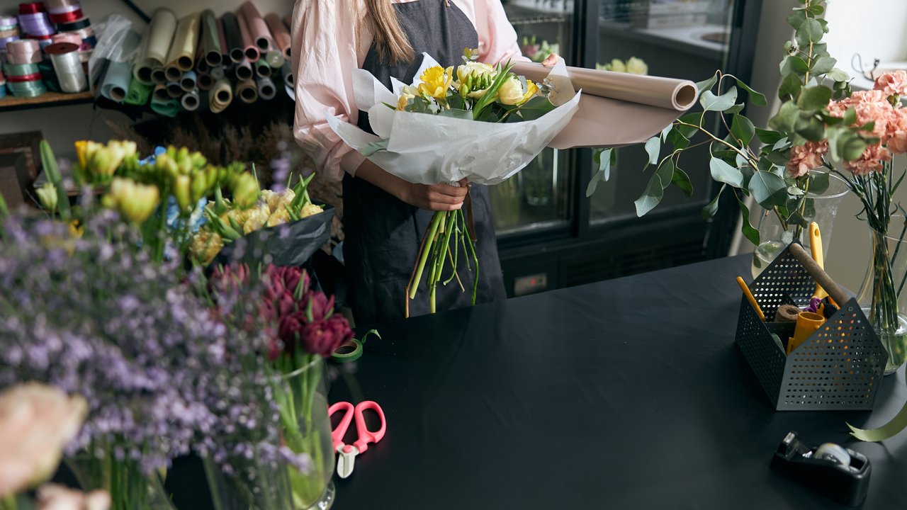 Florist holding beautiful flowers in a flower shop